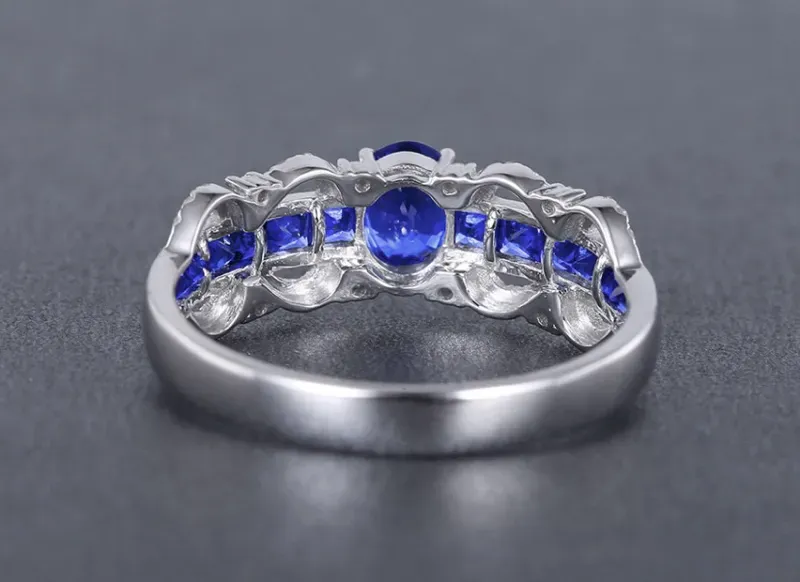 【18k金镶蓝宝石戒指 宝石参数:0.58+0.57ct 配石:钻石40颗,总重2.44克,圈口:13.5号(可改圈)】图2