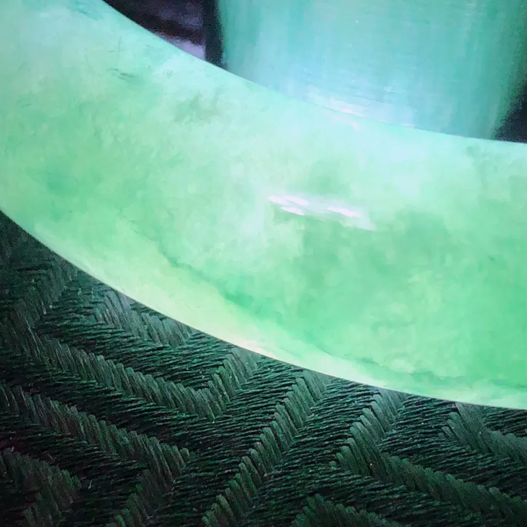 正圈56.8圈口，天然A货翡翠冰糯种飘绿宽条玉手镯，水润秀丽，飘绿优雅，种水十足，视觉甜美可人，恰到好处的美，十分高雅耐看，条形优美，上手优雅大方。尺寸56.8*12.2*7.3mm，重量：51.77g