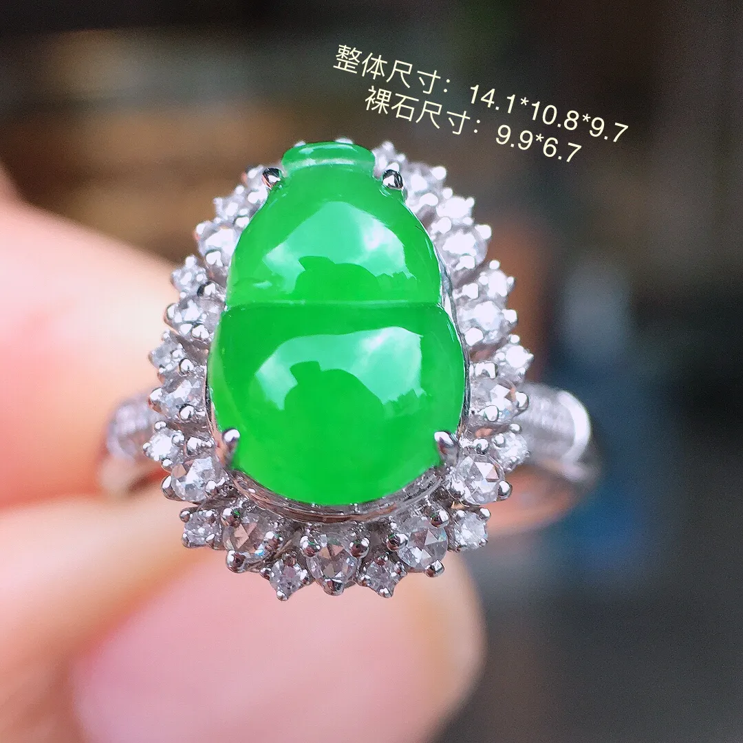 阳绿葫芦戒指，色泽均匀艳丽，玉质细腻，荧光感超
强，饱满水润，气质满满。18k
金豪华镶嵌