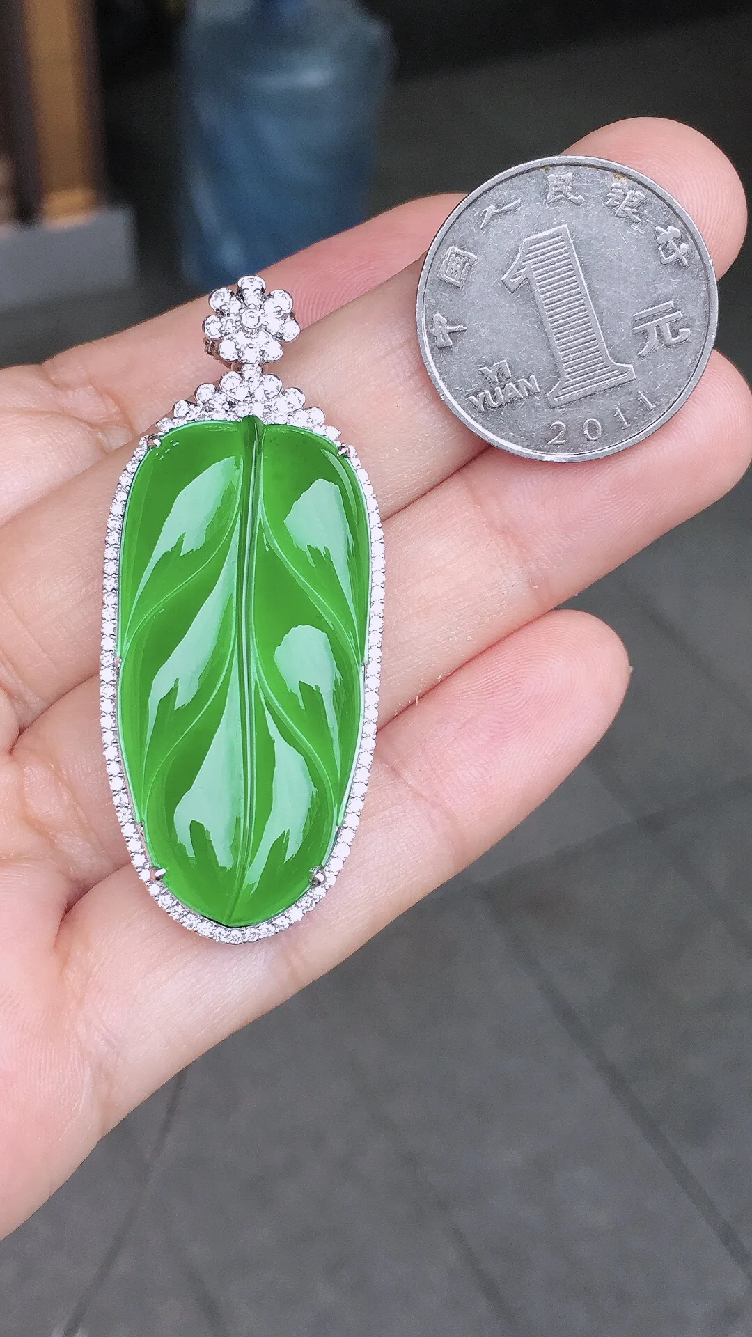 阳绿玉叶吊坠，色泽均匀艳丽，玉质细腻，荧光感超
强，饱满水润，气质满满。18k
金豪华镶嵌