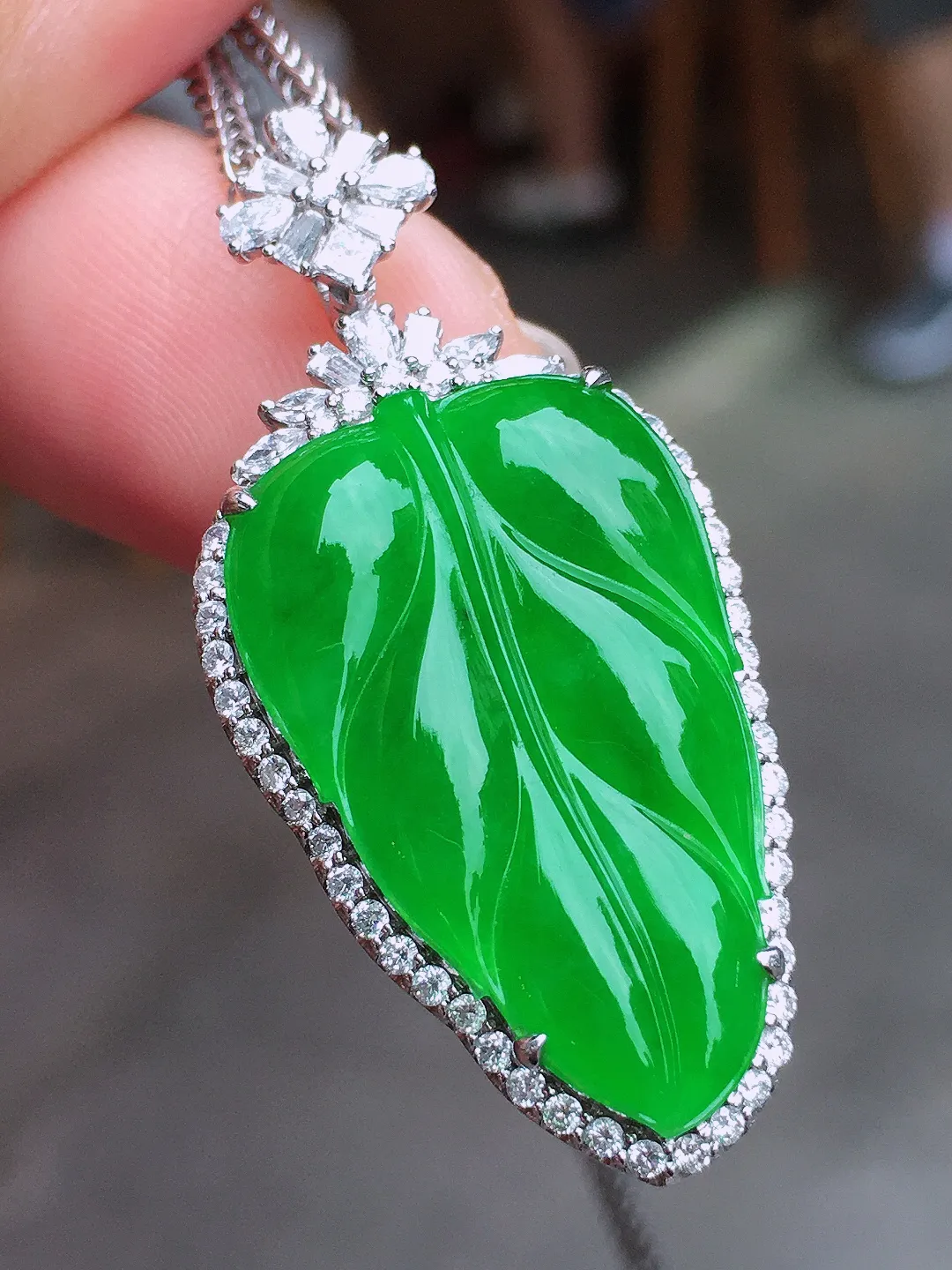阳绿玉叶吊坠，色泽均匀艳丽，玉质细腻，荧光感超
强，饱满水润，气质满满。18k
金豪华镶嵌