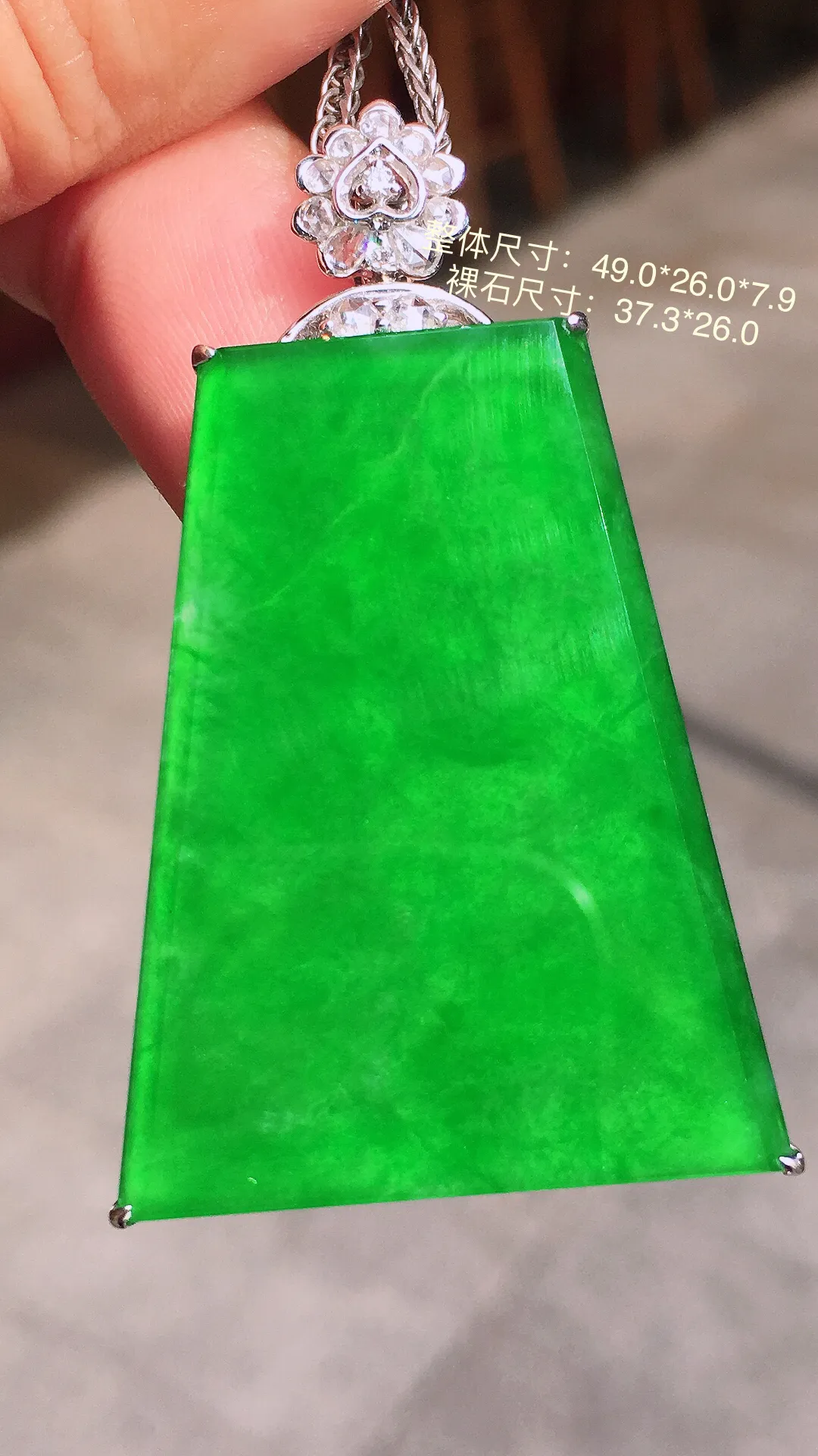 阳绿无事牌吊坠，色泽均匀艳丽，玉质细腻，荧光感超
强，饱满水润，气质满满。18k
金豪华镶嵌
