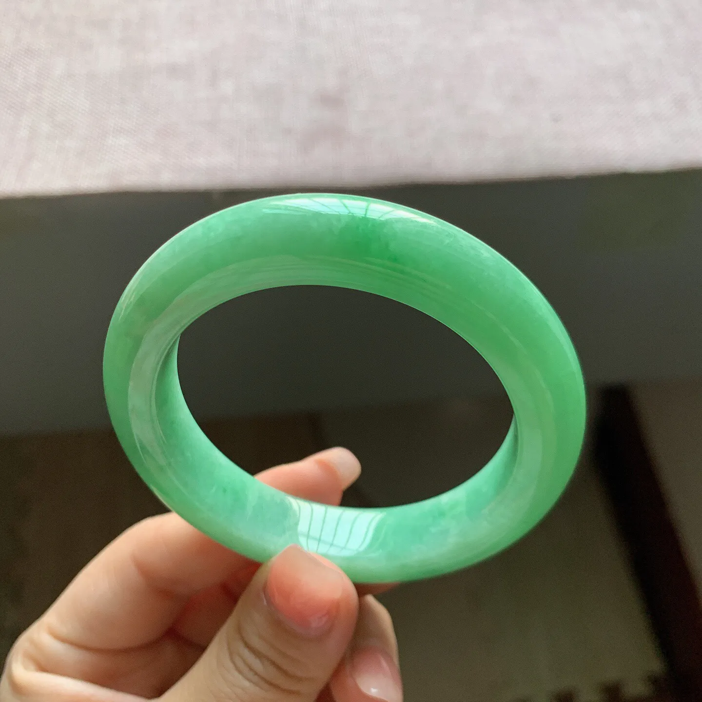 53-54圈口。自然光实拍，老坑冰润满绿正圈翡翠手镯，尺寸:54-11.6-9.7mm，重量65.18g，无纹裂，