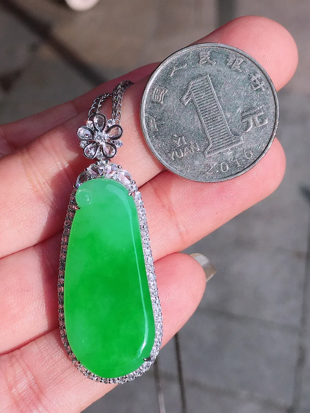 阳绿福瓜吊坠，色泽均匀艳丽，玉质细腻，荧光感超
强，饱满圆润，气质满满。18k
金豪华镶嵌