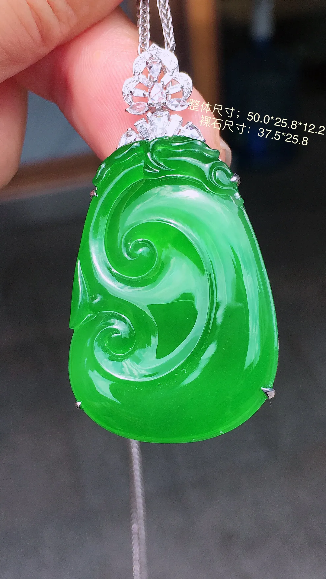 阳绿如意吊坠，色泽均匀艳丽，玉质细腻，荧光感超
强，饱满圆润，气质满满。18k
金豪华镶嵌