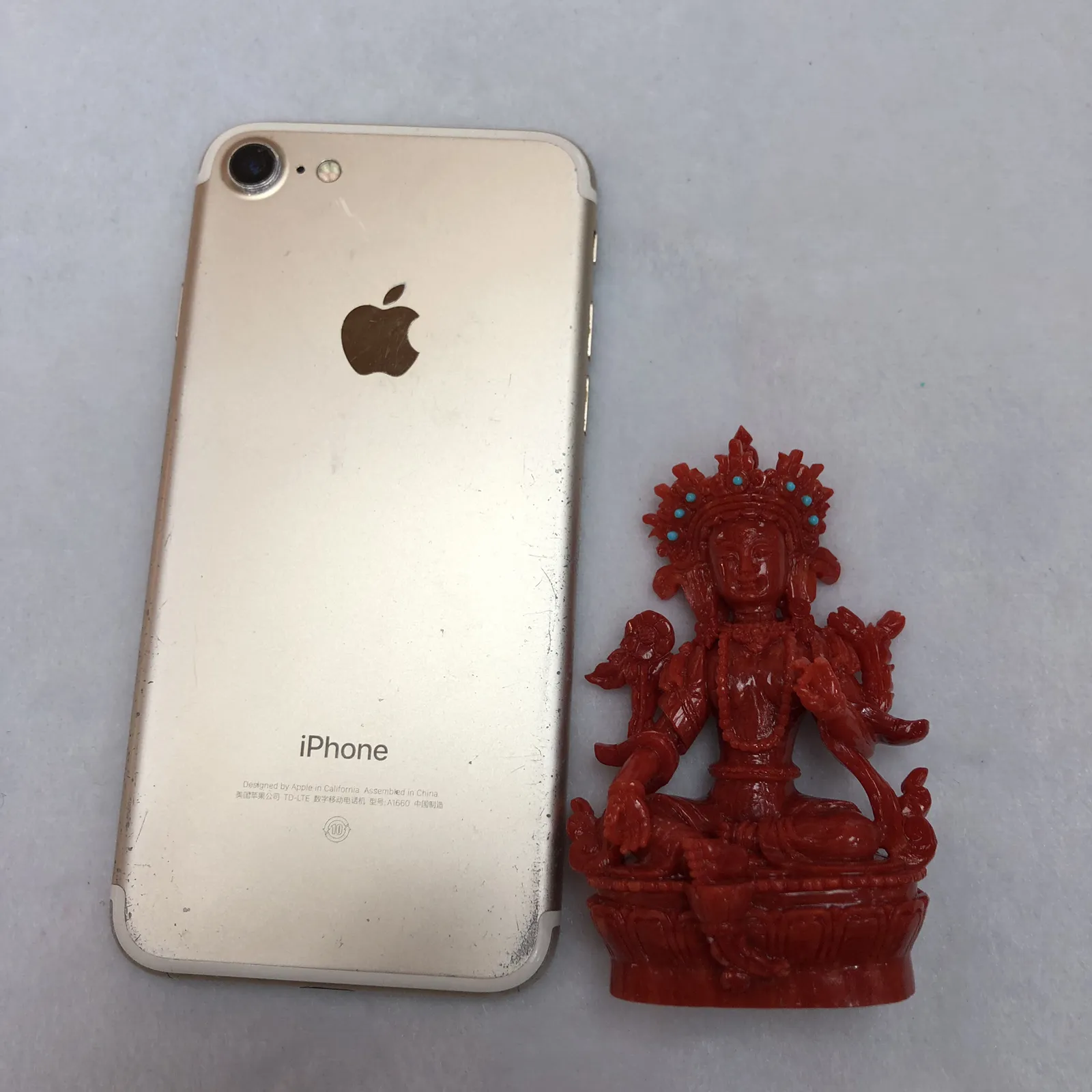 【天然红珊瑚拼接绿镀母小佛摆件】意大利产地，沙丁珊瑚料，深红颜色，釆用台湾拼接手工工艺，精雕细镂，底部有开孔可藏经文，手工工序复杂，高约85mm，宽约51mm，厚39.8mm，重量75.5克。天然美松点缀！可手持红珊瑚沙丁大枝拼接绿镀母。收藏供奉价值高！