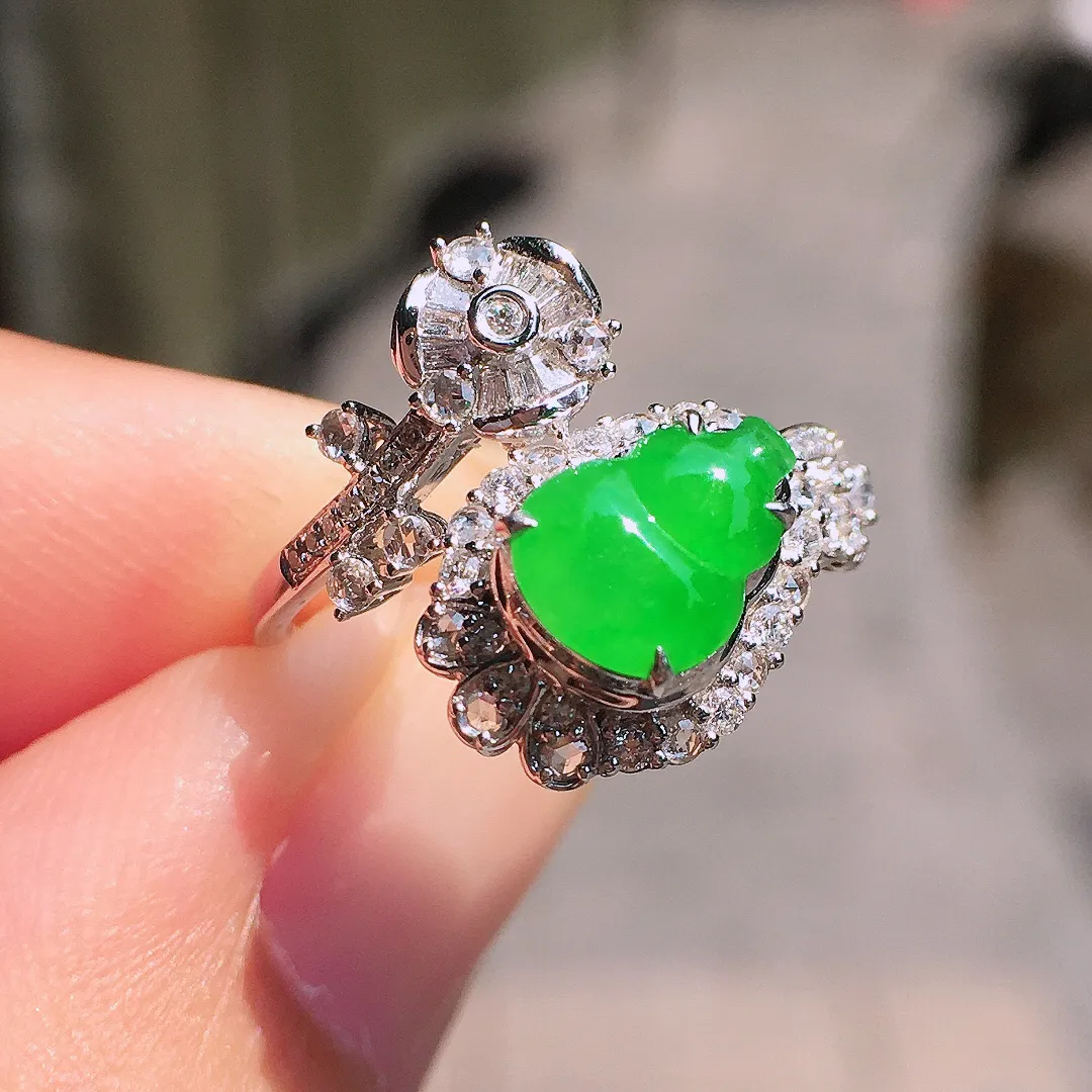 阳绿葫芦戒指，色泽均匀艳丽，玉质细腻，荧光感超
强，饱满圆润，气质满满。18k
金豪华镶嵌