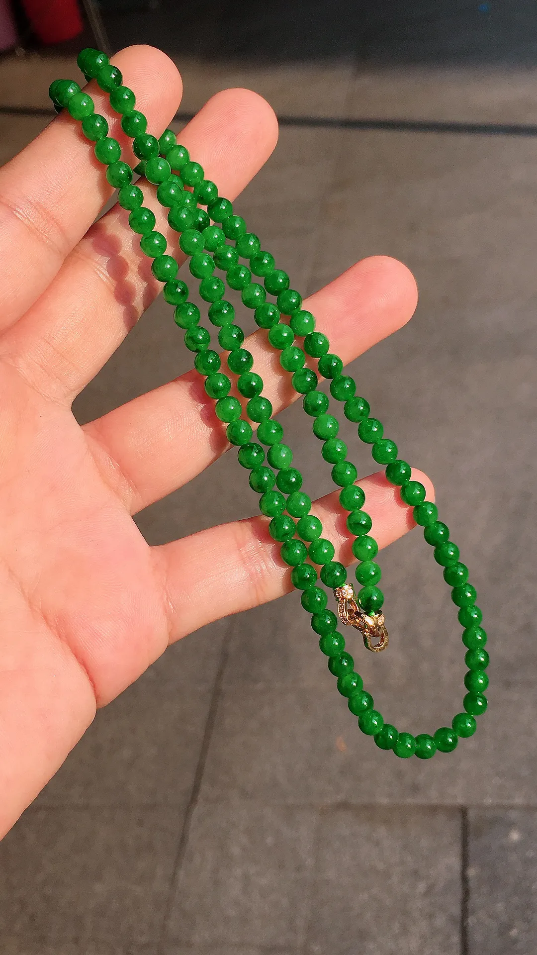 阳绿珠子项链，色泽均匀艳丽，玉质细腻，荧光感超
强，饱满圆润，气质满满。18k
金豪华镶嵌
