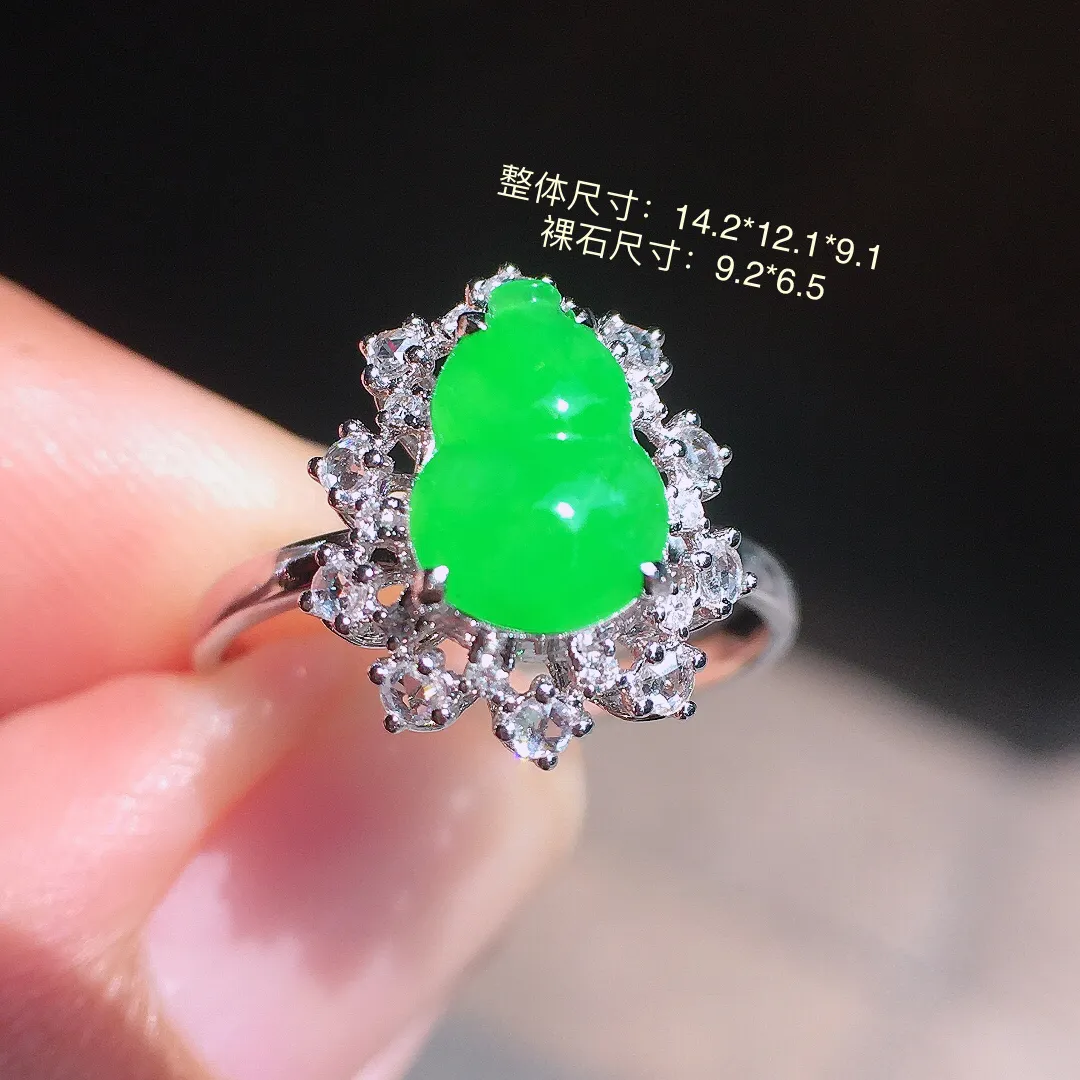 阳绿葫芦戒指，色泽均匀艳丽，玉质细腻，荧光感超
强，饱满圆润，气质满满。18k
金豪华镶嵌