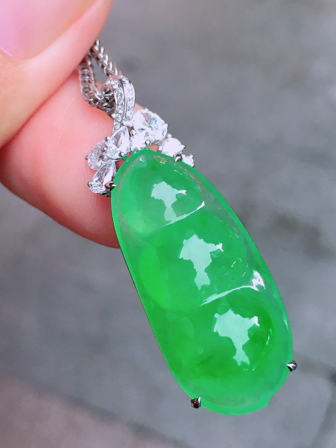 冰绿福豆吊坠，色泽均匀艳丽，玉质细腻，荧光感超
强，饱满圆润，气质满满。18k
金豪华镶嵌