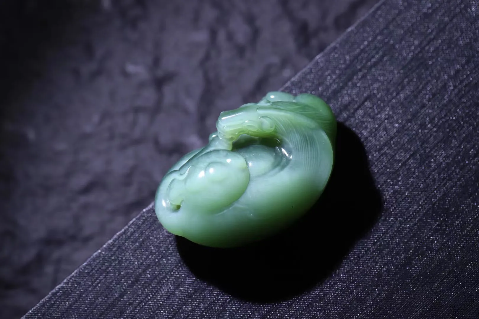 精致美物
【骏马】7号坑老料碧玉碧玉猫眼，荧光闪闪，油润十足。纯手工精雕,，写实风格、线条柔顺流畅，神气俊朗。实力派手笔，刀笔干练果断，大气辉煌。纵横山河气势如虹，长鬃飞扬，嘶鸣响彻长空，四蹄生风，草原无际任驰骋，翻蹄亮掌疾如风。此马若遂千里志，追风犹可到天涯！
【规格】57-33-24mm，68g