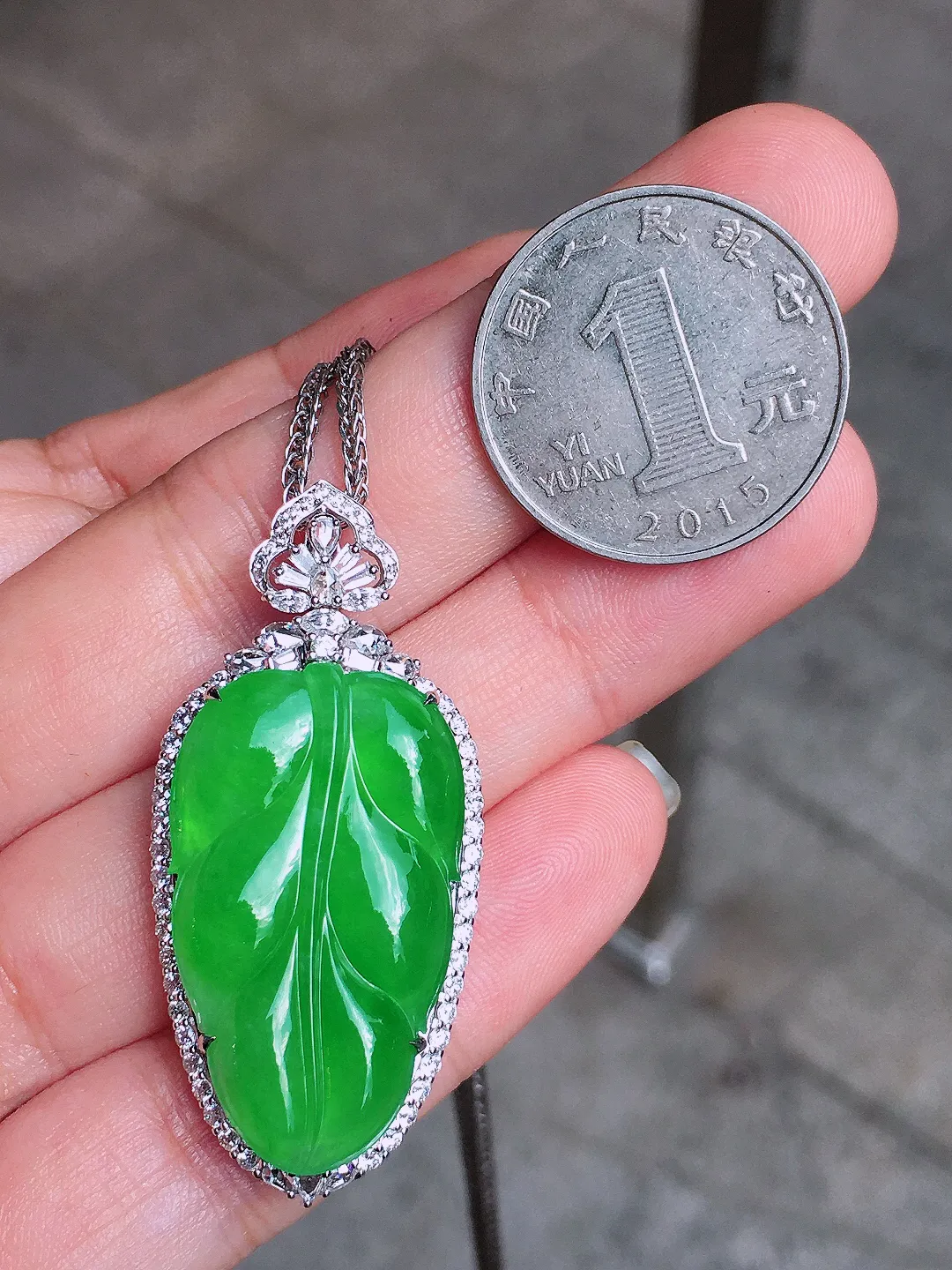 阳绿玉叶吊坠，色泽均匀艳丽，玉质细腻，荧光感超
强，饱满圆润，简单大气，18k
金豪华镶嵌