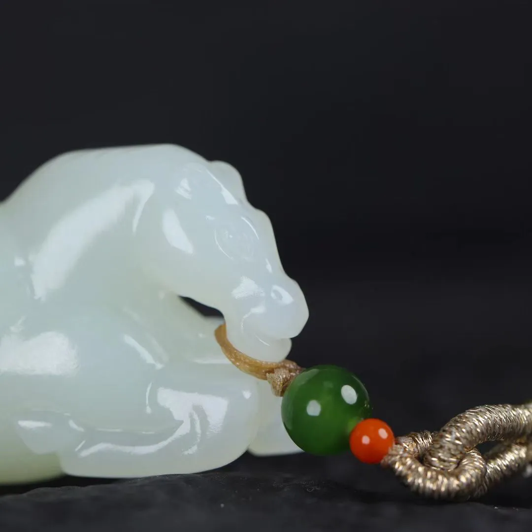 祥瑞臻品
【马~丰年载福】和田白玉精雕瑞马，玉质凝若羊脂膏腴，透光处泛起蜜蜡般柔晕。马身圆润如满月悬空，丰腴而不失矫健，鬃尾卷曲似祥云凝脂，四蹄敦实若莲台承露。肌骨线条浑圆流转，腹部饱满暗合聚财之相，回首凝眸时玉光温润生暖意，既可陈于案头作五谷丰登之景，亦能盈握掌心触福泽流转。
【规格】48-22-21mm,31.5g