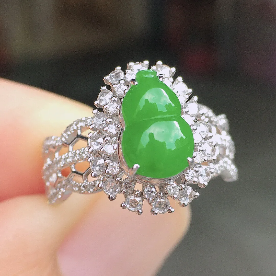 阳绿葫芦戒指，色泽均匀艳丽，玉质细腻，荧光感超
强，饱满圆润，尽显优雅气质，18k
金豪华镶嵌