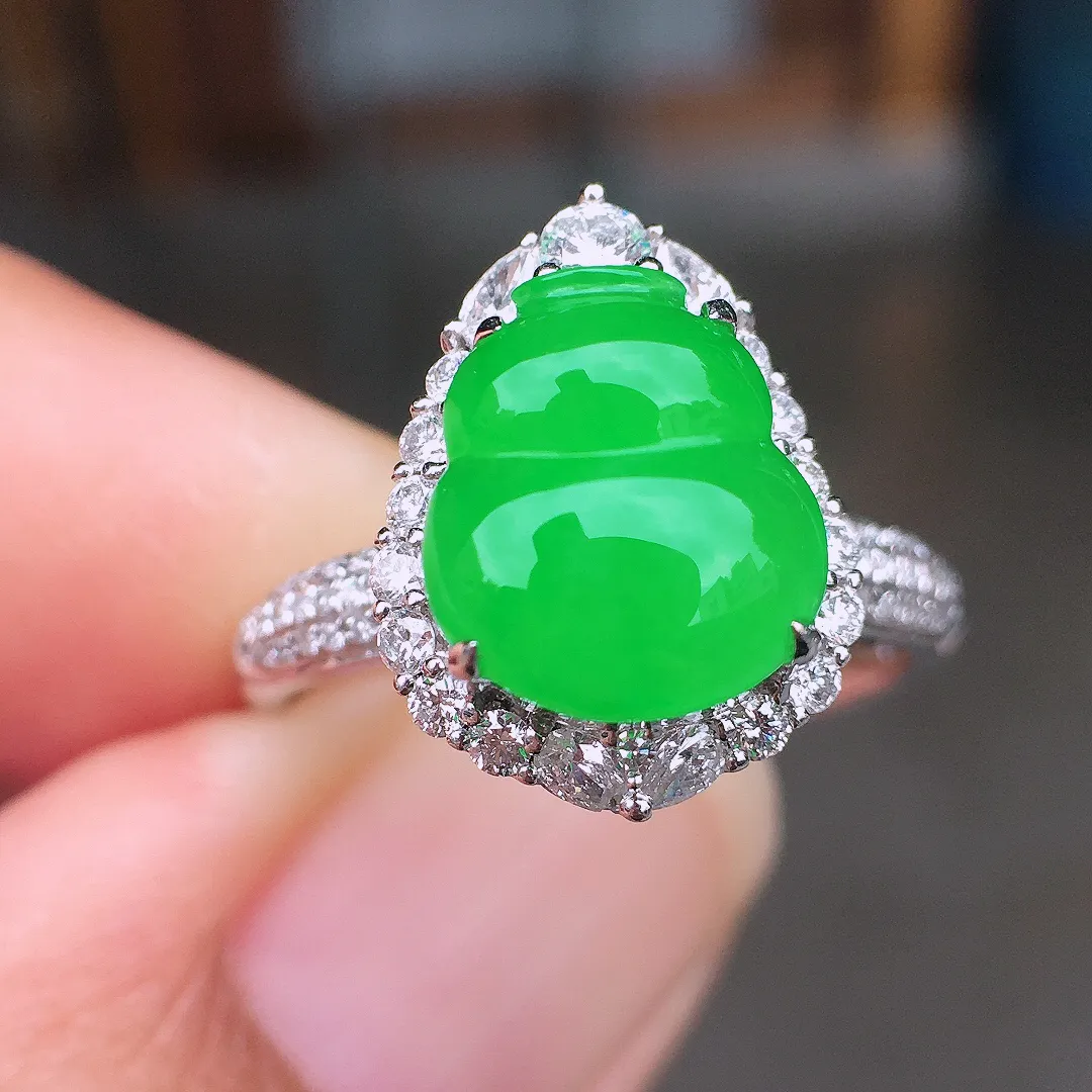 阳绿葫芦戒指，色泽均匀艳丽，玉质细腻，荧光感超
强，饱满圆润，尽显优雅气质，18k
金豪华镶嵌