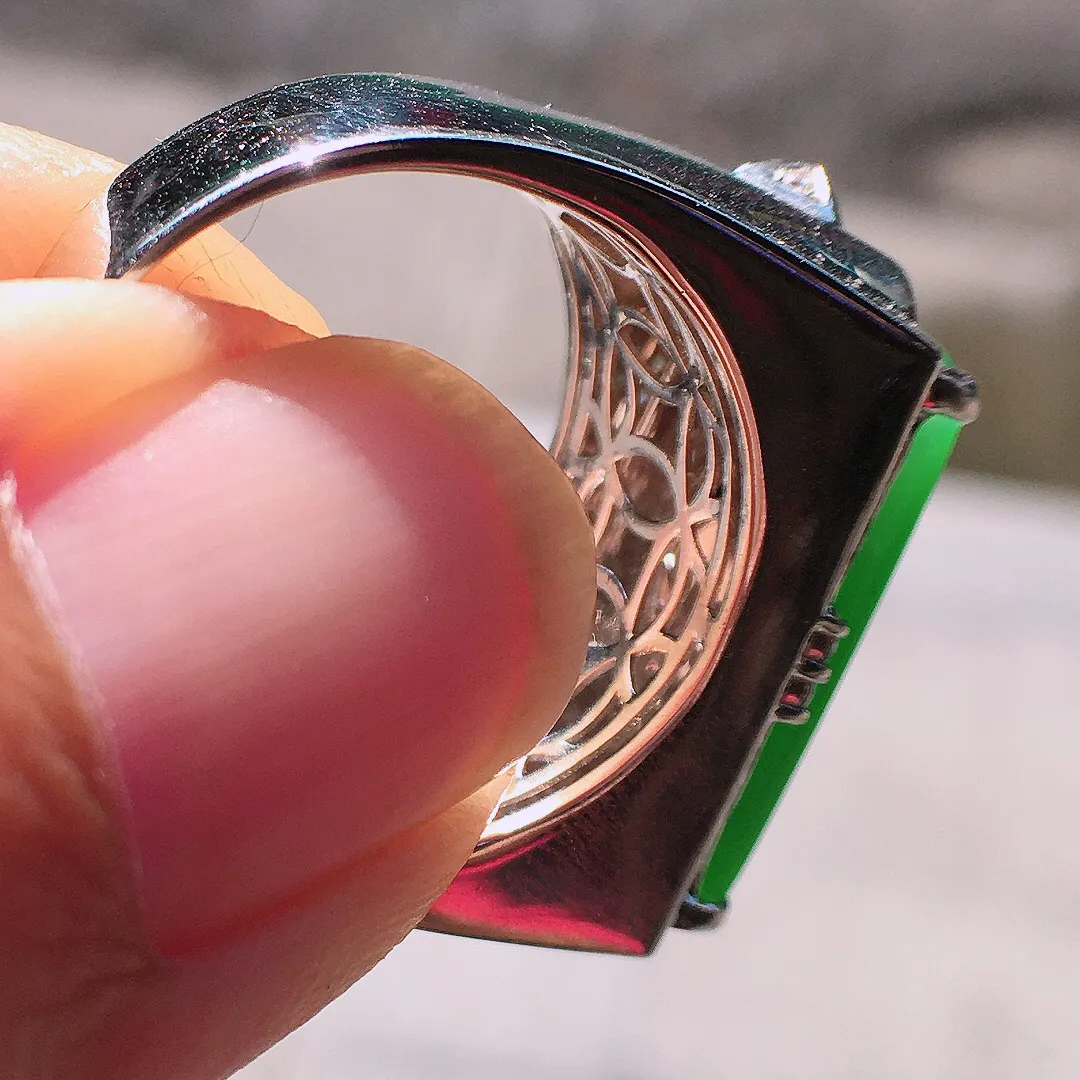 阳绿马鞍戒指，色泽均匀艳丽，玉质细腻，荧光感超
强，饱满圆润，尽显优雅气质，18k
金豪华镶嵌