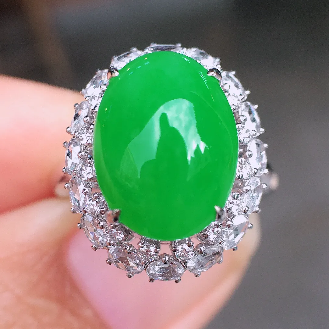 阳绿蛋面戒指，色泽均匀艳丽，玉质细腻，荧光感超
强，饱满圆润，尽显优雅气质，18k
金豪华镶嵌