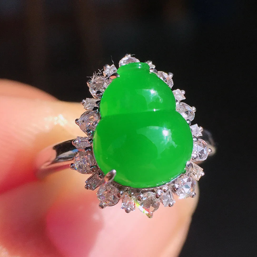 阳绿葫芦戒指，色泽均匀艳丽，玉质细腻，荧光感超
强，饱满圆润，尽显优雅气质，18k
金豪华镶嵌
