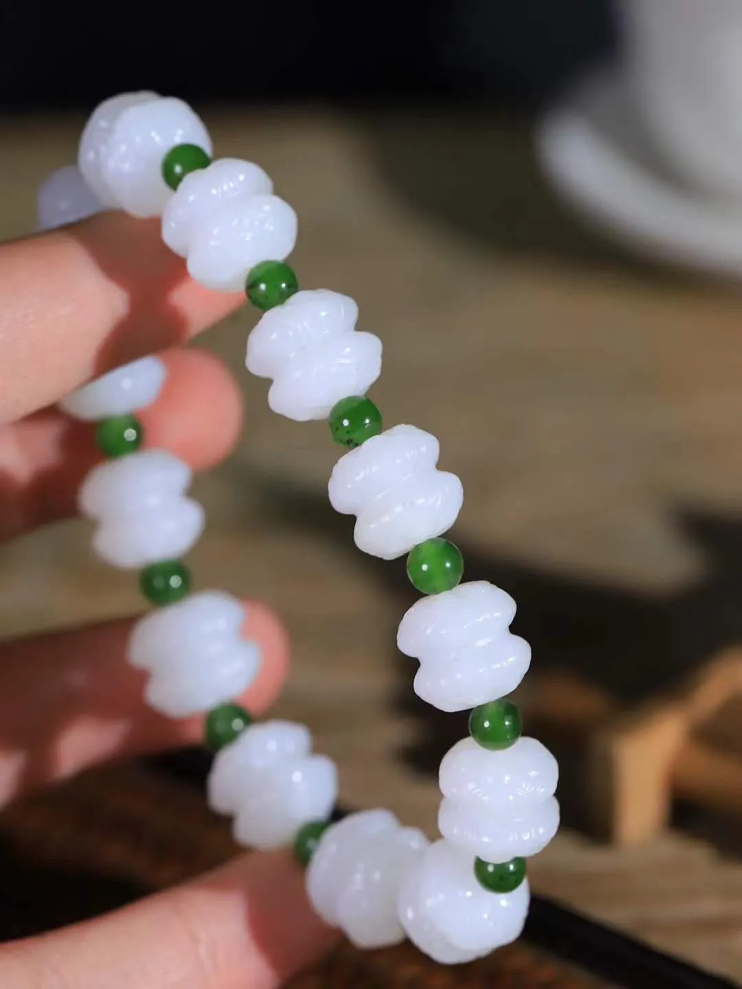 【莲花.手串】

精品和田玉白玉莲花手串，器形优雅，小巧精致，翠色浓郁，玉质细腻油润、手感上佳，颗颗精雕莲花，将荷花出淤泥而不染，濯清涟而不妖的气韵，刻画的淋漓尽致。尺寸取一11.5-12.8-12.2mm，重43.6克 FDA-361101220