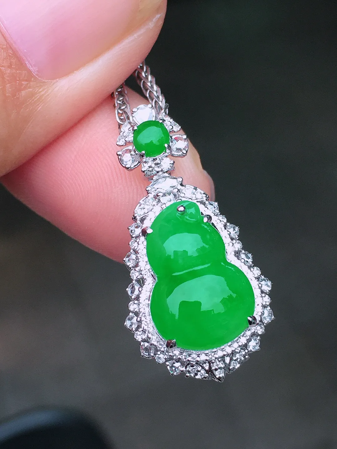 阳绿葫芦吊坠，色泽均匀艳丽，玉质细腻，荧光感超
强，饱满圆润，尽显优雅气质，18k
金豪华镶嵌