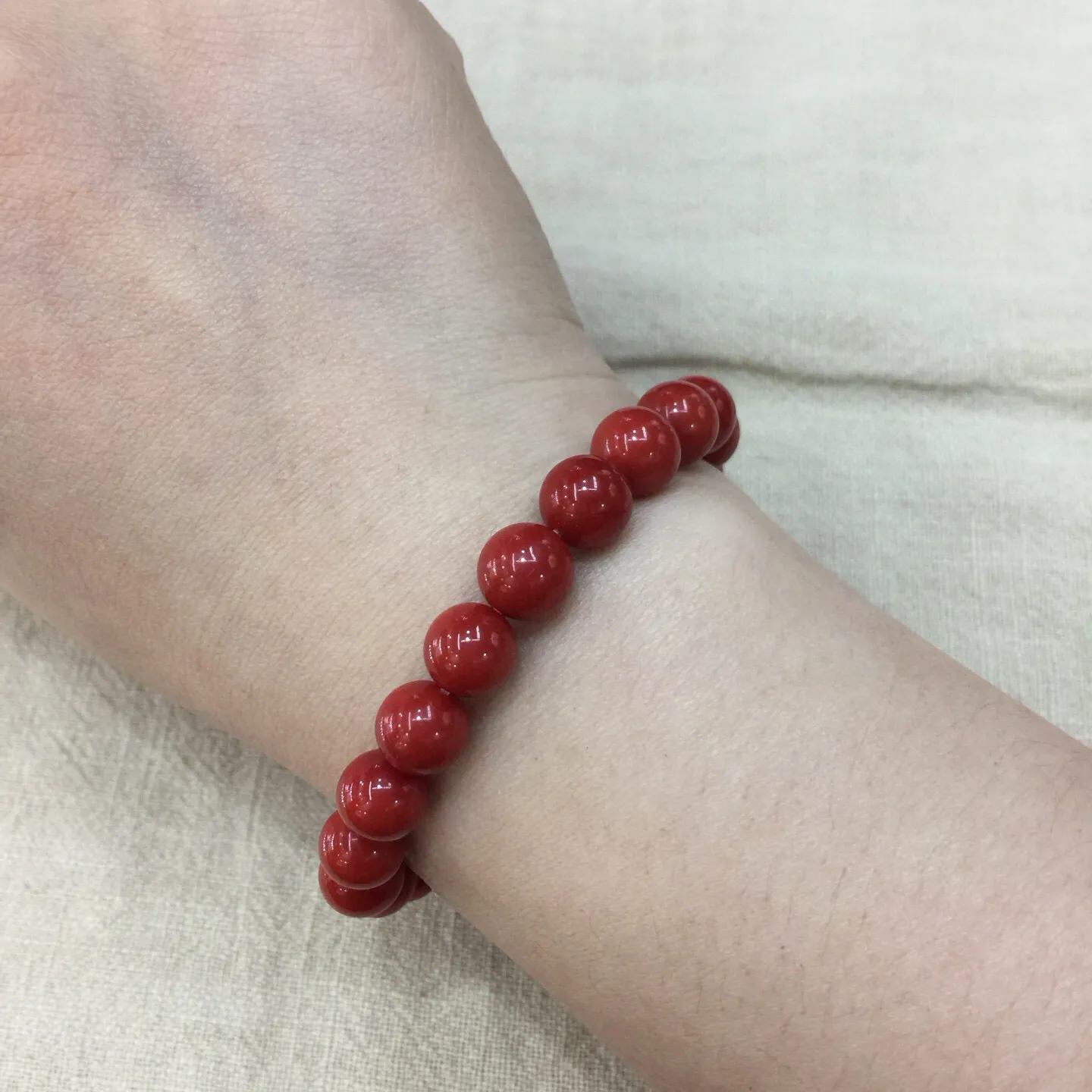 【天然近牛血珊瑚9.28mm大圆珠弹力手串】近牛血红颜色，光泽柔润透亮，直径约为9.28-8.5mm，重量为20.59克，珊瑚本为佛教珍宝，来自深海千年生长，有生长纹，属于有机宝石，气场强大，材料意大利沙丁材料，稀少珍贵！每粒均为天然无添加无修补！收藏精品！传承宝贝！