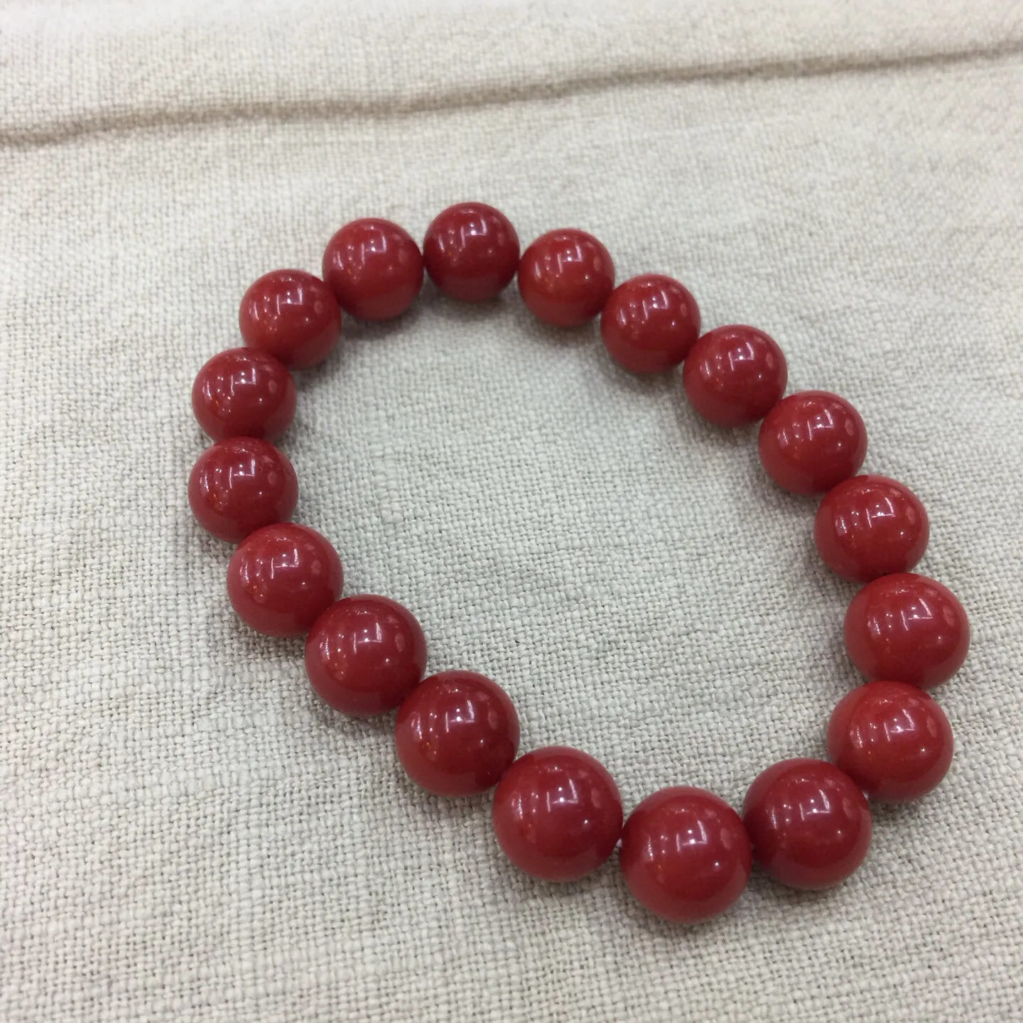 【天然近牛血珊瑚10mm大圆珠弹力手串】近牛血红颜色，光泽柔润透亮，直径约为10.15-9.36mm