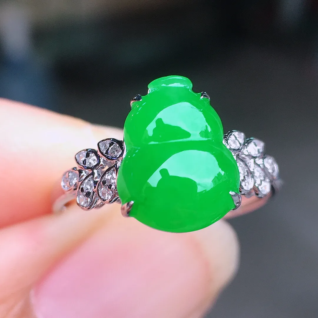 阳绿葫芦戒指，色泽均匀艳丽，玉质细腻，荧光感超
强，饱满圆润，尽显优雅气质，18k
金豪华镶嵌