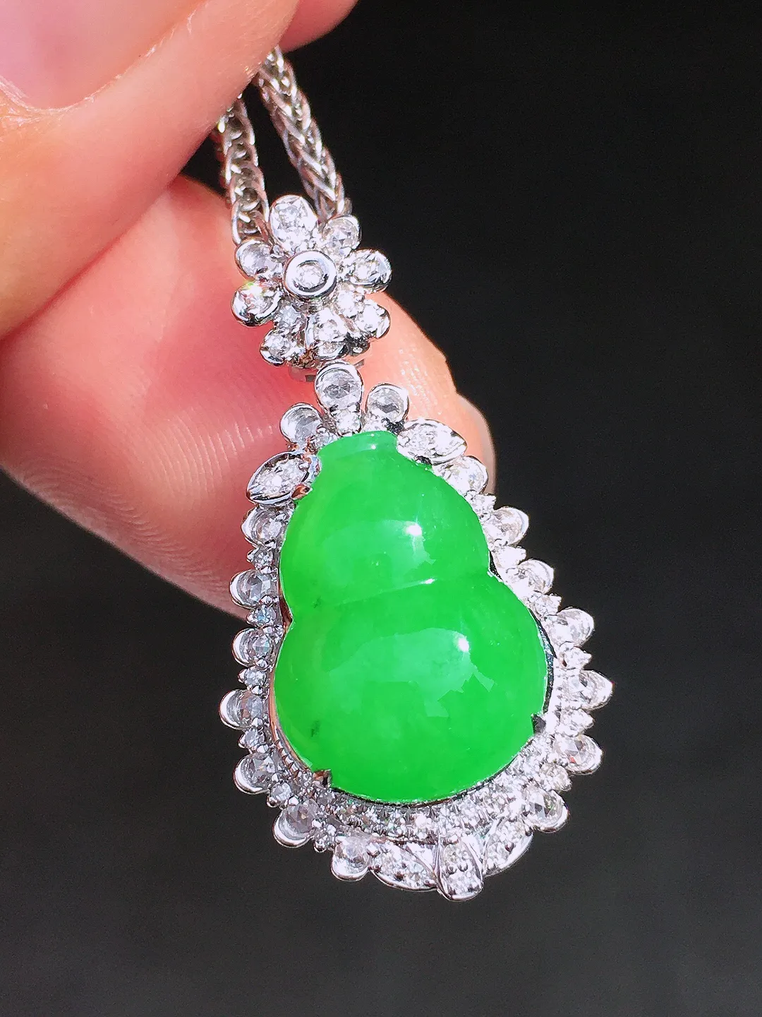 阳绿葫芦吊坠，色泽均匀艳丽，玉质细腻，荧光感超
强，饱满圆润，尽显优雅气质，18k
金豪华镶嵌