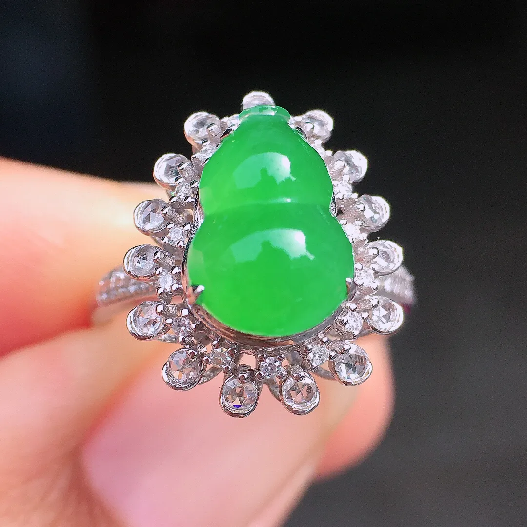 阳绿葫芦戒指，色泽均匀艳丽，玉质细腻，荧光感超
强，饱满圆润，尽显优雅气质，18k
金豪华镶嵌