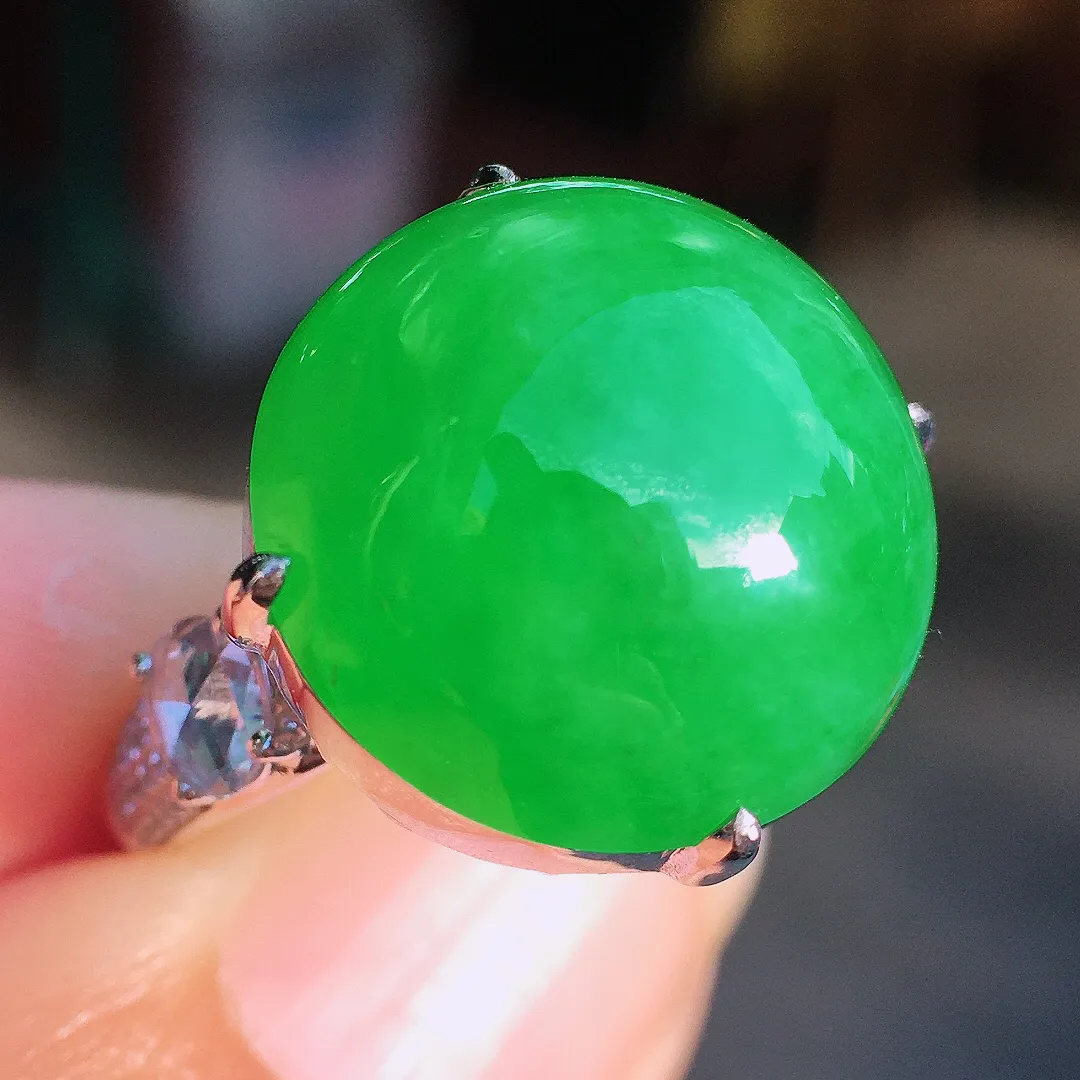 阳绿蛋面戒指，色泽均匀艳丽，玉质细腻，荧光感超
强，饱满圆润，尽显优雅气质，18k
金豪华镶嵌