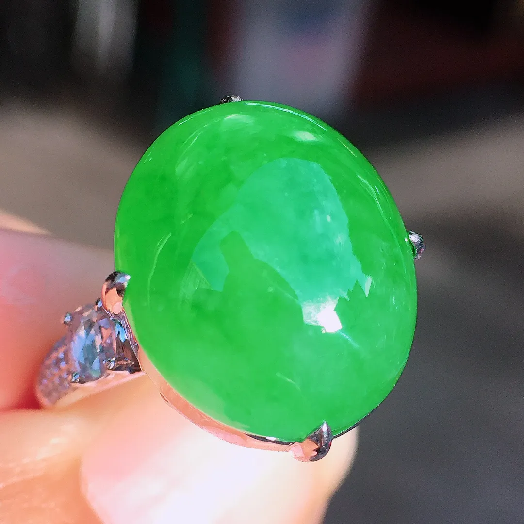 阳绿蛋面戒指，色泽均匀艳丽，玉质细腻，荧光感超
强，饱满圆润，尽显优雅气质，18k
金豪华镶嵌