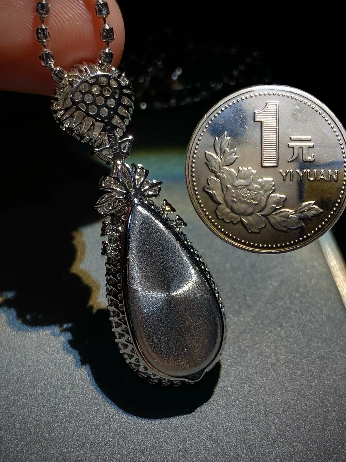 蜡绿翡翠水滴吊坠，
裸石8.5-8.2-1.8mm，24-12-3.2mm，
整体42.5-15-10mm，8.63g，
18K金，南非钻，不配链