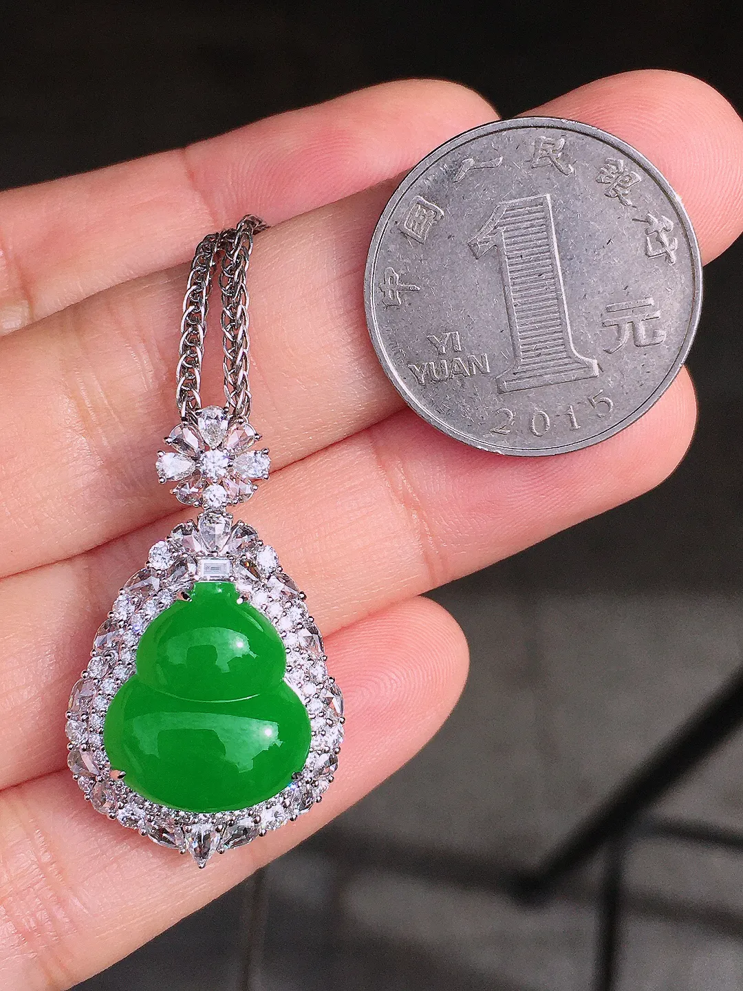 阳绿葫芦吊坠，色泽均匀艳丽，玉质细腻，荧光感超
强，饱满圆润，尽显优雅气质，18k
金豪华镶嵌