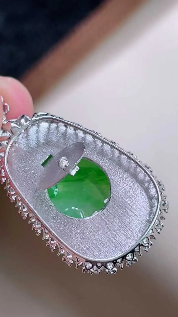 【翡翠名称】18K金豪华镶钻冰阳绿如意吊坠
【翡翠尺寸】含金33.8/17.9/6.3mm裸石23/15.5
【翡翠描述】缅甸天然翡翠A货，种老水足，玉质细腻，色泽靓丽，性价比高，佩戴效果好！