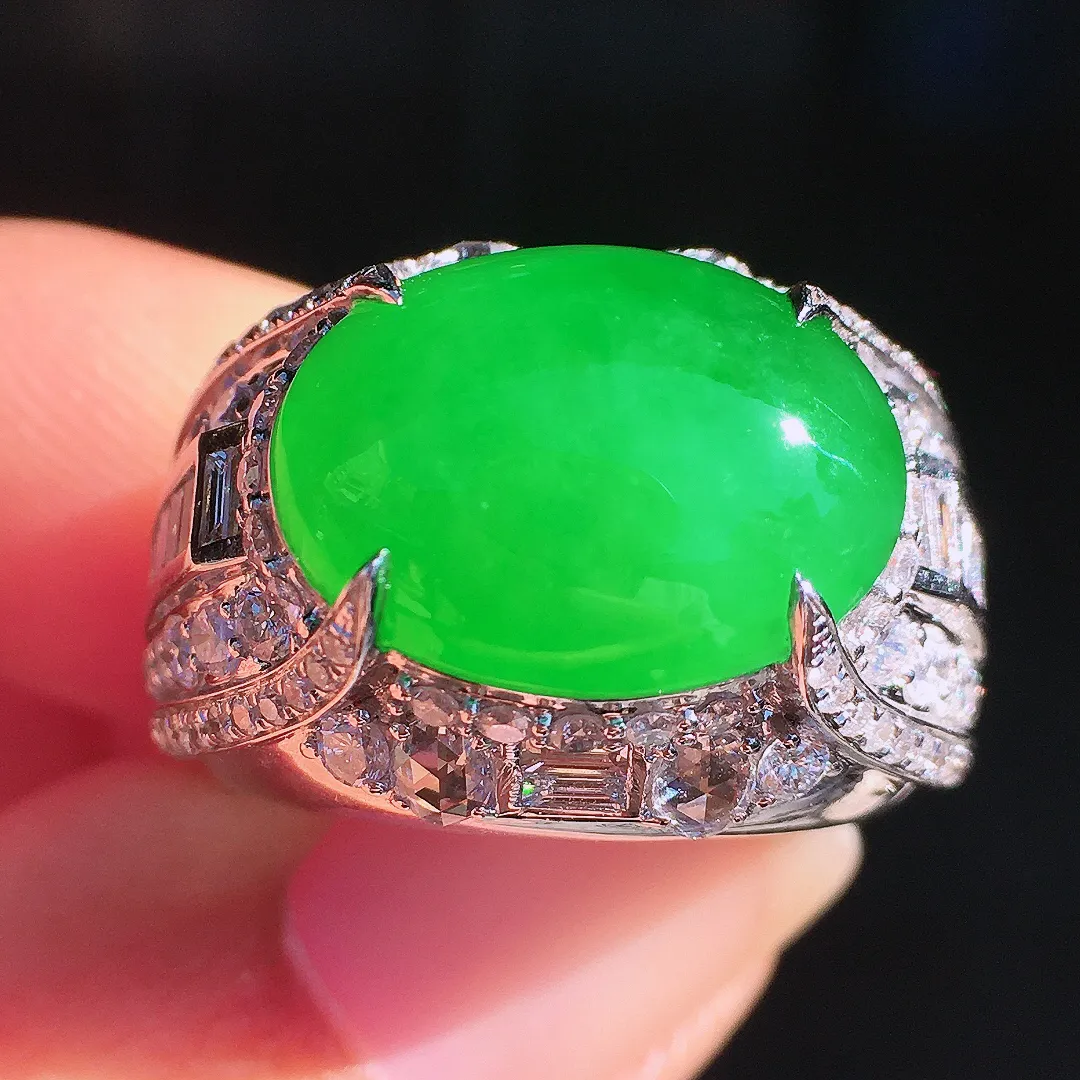 阳绿马鞍戒指，色泽均匀艳丽，玉质细腻，荧光感超
强，饱满圆润，尽显优雅气质，18k
金豪华镶嵌