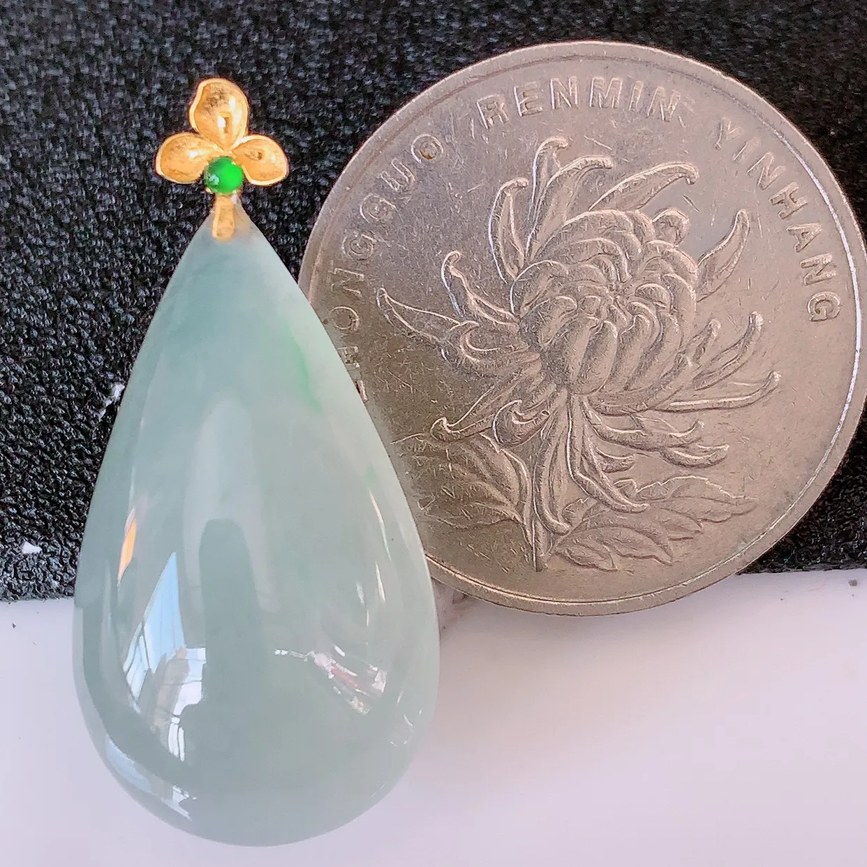 18K金镶嵌冰种飘绿翡翠水滴吊坠，品相佳，颜色漂亮，佩戴时尚优雅，尽显气质。水滴寓意“水滴聚财，坚持不懈，如水爱心” #94.27