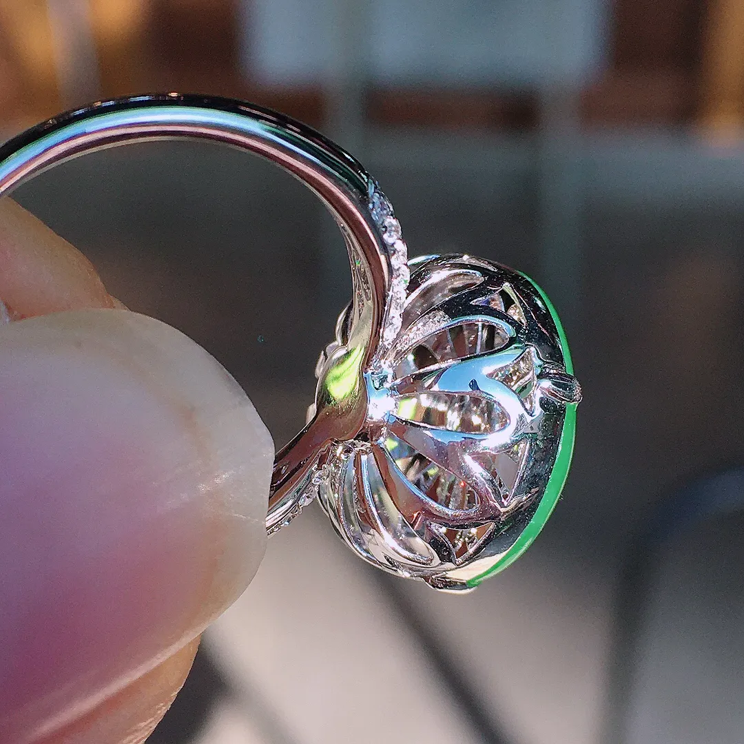 阳绿蛋面戒指，色泽均匀艳丽，玉质细腻，荧光感超
强，饱满圆润，尽显优雅气质，18k
金豪华镶嵌