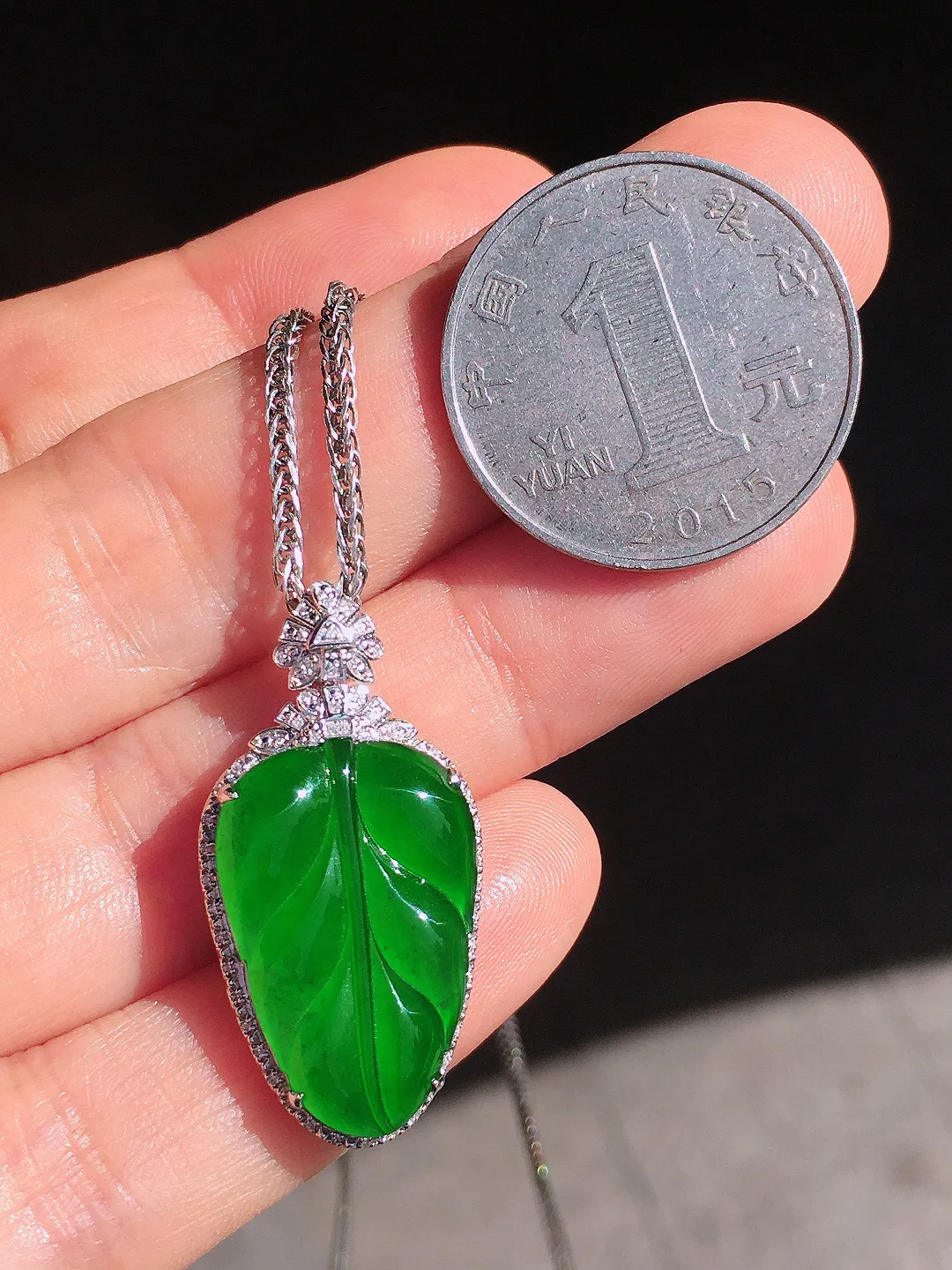 阳绿玉叶吊坠，色泽均匀艳丽，玉质细腻，荧光感超
强，饱满圆润，尽显优雅气质，18k
金豪华镶嵌