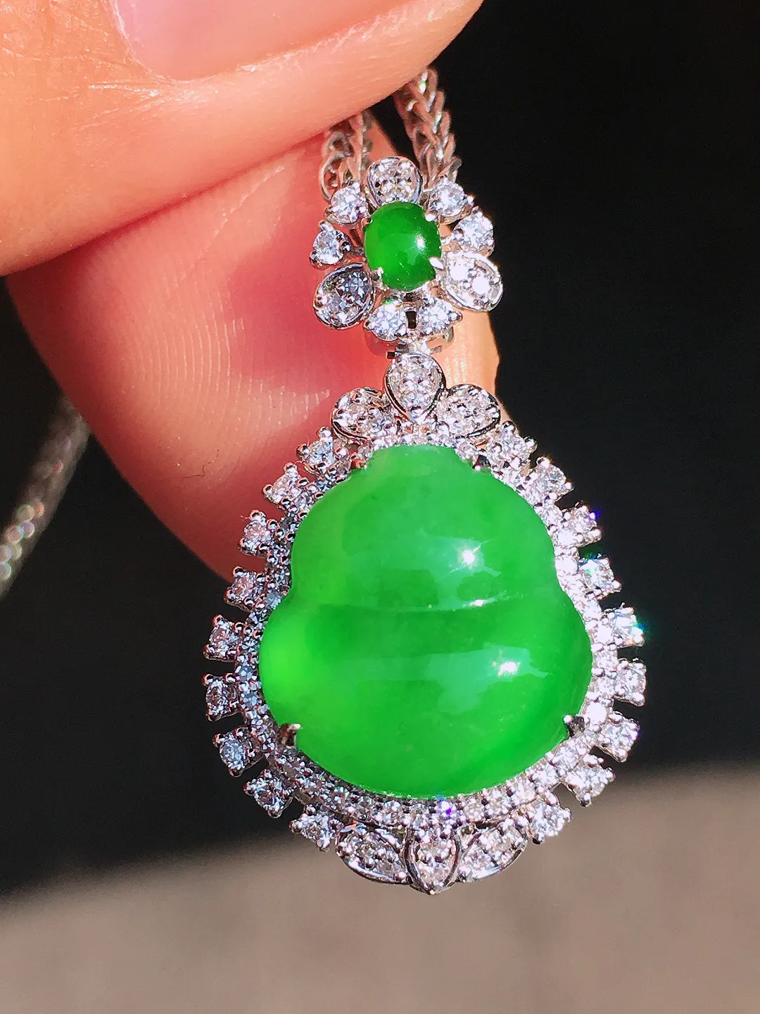 阳绿葫芦吊坠，色泽均匀艳丽，玉质细腻，荧光感超
强，饱满圆润，尽显优雅气质，18k
金豪华镶嵌