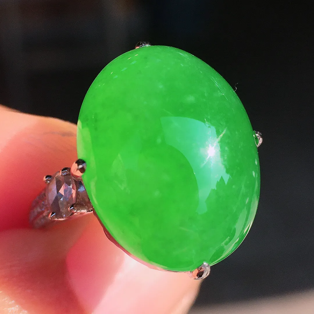 阳绿蛋面戒指，色泽均匀艳丽，玉质细腻，荧光感超
强，饱满圆润，尽显优雅气质，18k
金豪华镶嵌