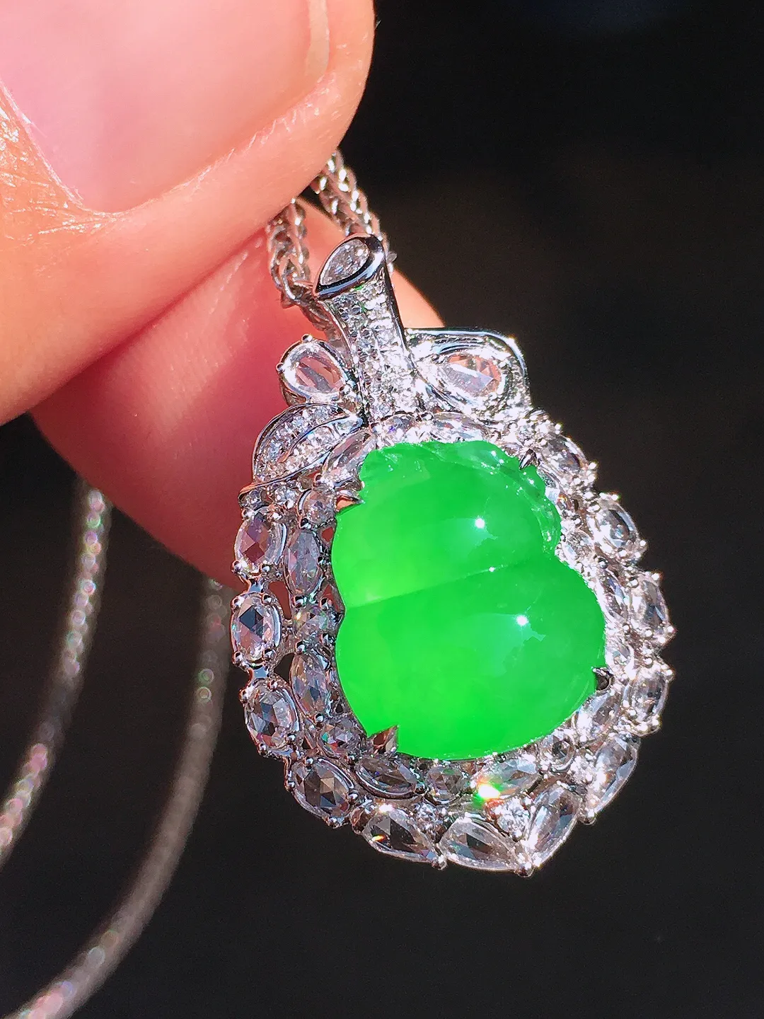 阳绿葫芦吊坠，色泽均匀艳丽，玉质细腻，荧光感超
强，饱满圆润，尽显优雅气质，18k
金豪华镶嵌