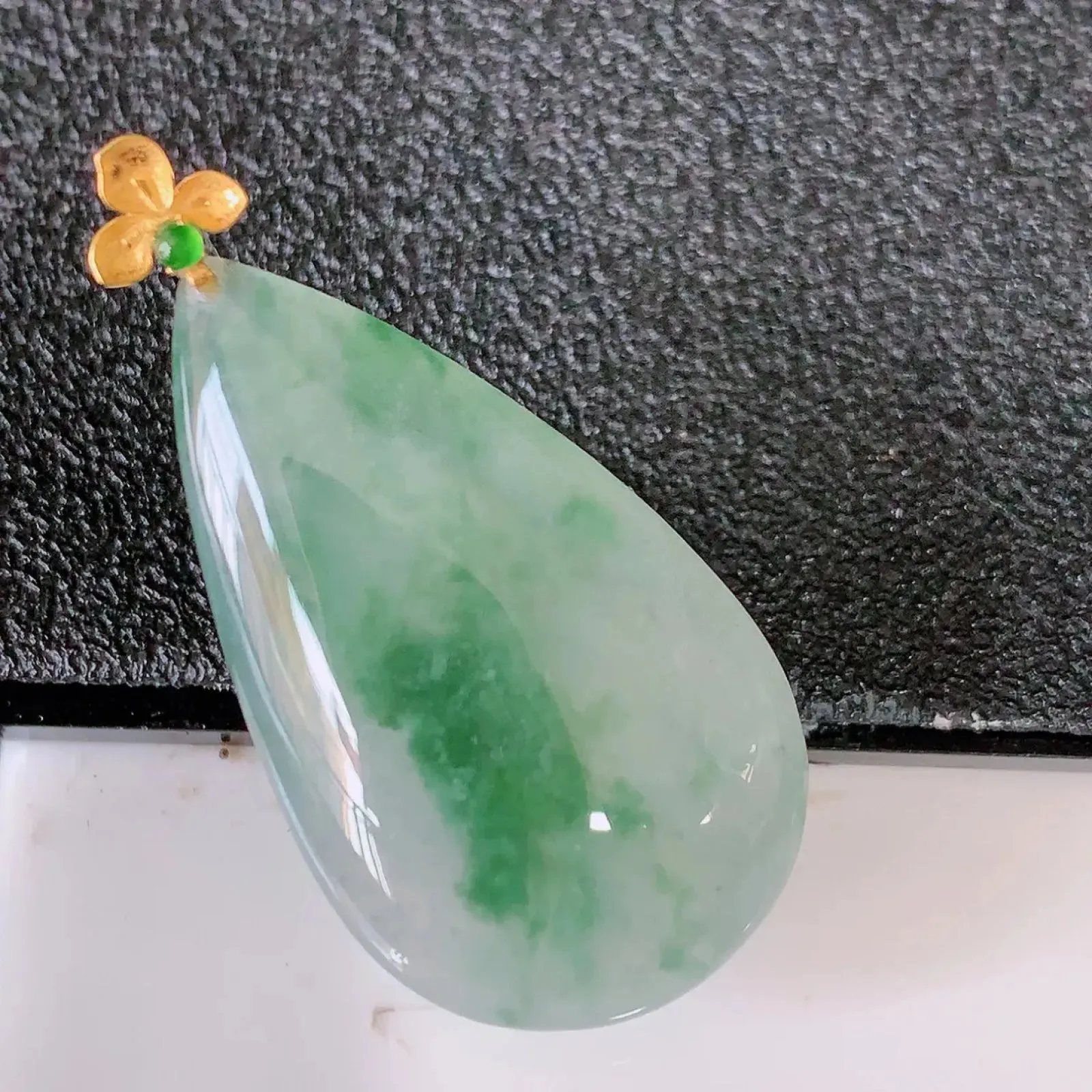 18k金镶嵌冰种飘花翡翠水滴吊坠  款式新颖，佩戴效果时尚出众，尽显气质，水润精细，美感十足。#121.3整体33裸石28-16.8-5.5mm