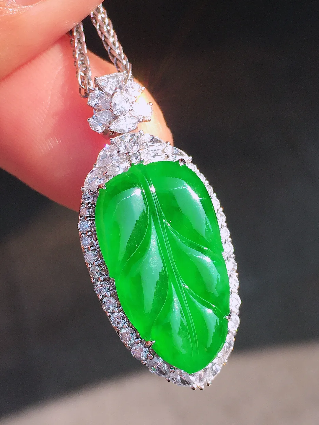 阳绿玉叶吊坠，色泽均匀艳丽，玉质细腻，荧光感超
强，饱满圆润，尽显优雅气质，18k
金豪华镶嵌