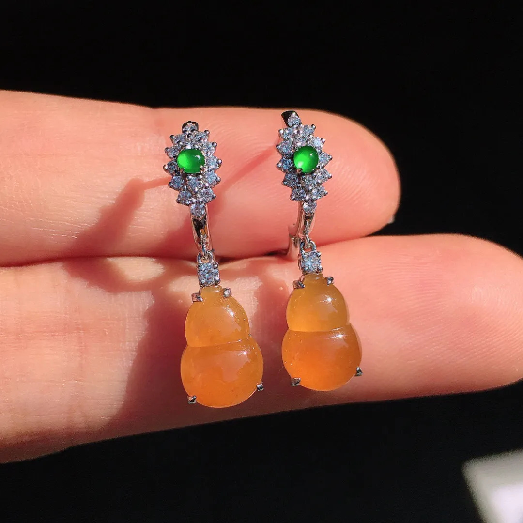 黄翡葫芦耳坠，色泽均匀艳丽，玉质细腻，荧光感超
强，饱满圆润，尽显优雅气质，18k
金豪华镶嵌