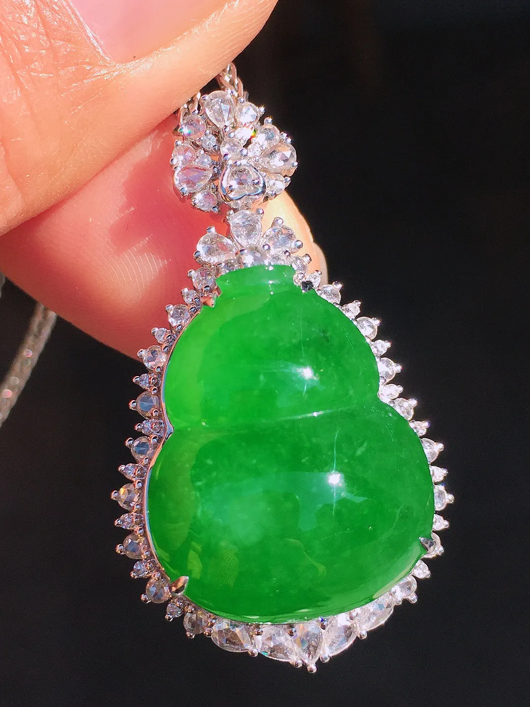 阳绿葫芦吊坠，色泽均匀艳丽，玉质细腻，荧光感超
强，饱满圆润，尽显优雅气质，18k
金豪华镶嵌