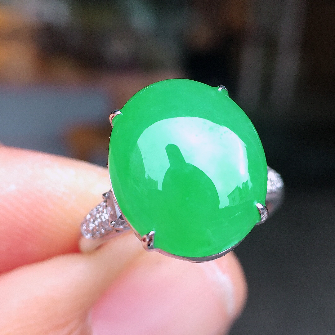 阳绿蛋面戒指，色泽均匀艳丽，玉质细腻，荧光感超
强，饱满圆润，尽显优雅气质，18k
金豪华镶嵌