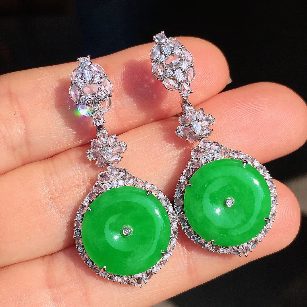 阳绿平安扣耳坠，色泽均匀艳丽，玉质细腻，荧光感超
强，饱满圆润，尽显优雅气质，18k
金豪华镶嵌