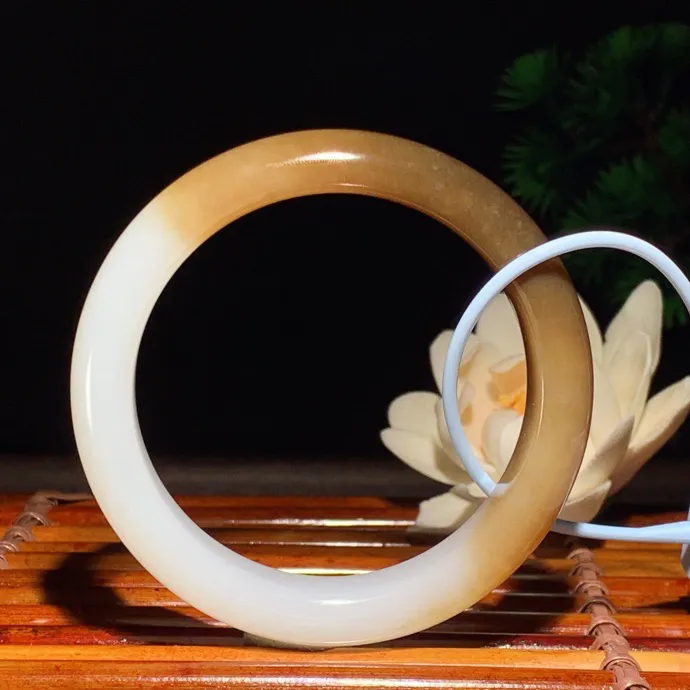 56圈口 新疆和田玉且末糖手镯 且末糖半山半水手镯 56圈口条宽 11.5厚8重53.5克。玉质细腻油润。手推出油。佩戴高端典雅。lt260125