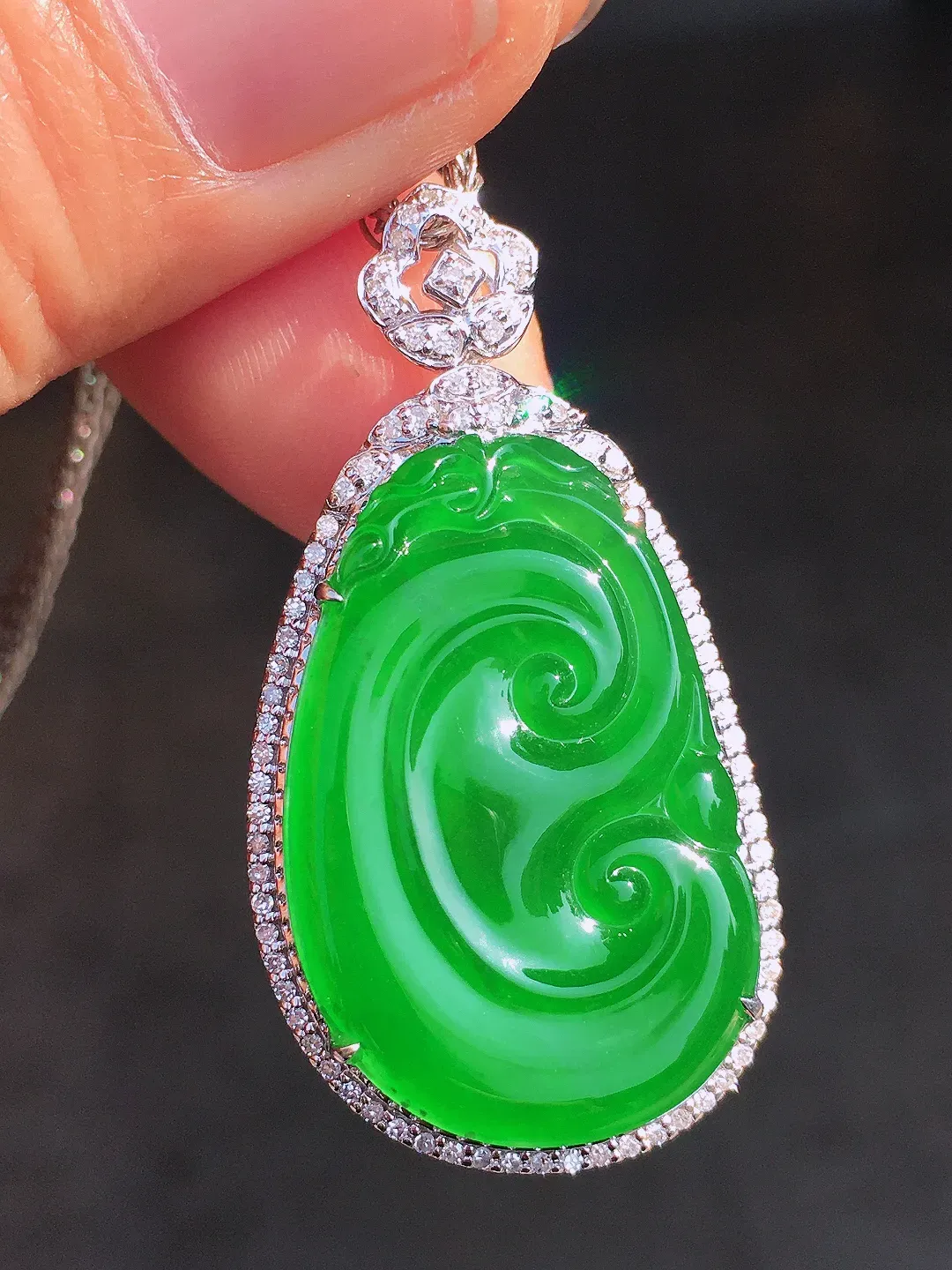 阳绿如意吊坠，色泽均匀艳丽，玉质细腻，荧光感超
强，饱满圆润，尽显优雅气质，18k
金豪华镶嵌