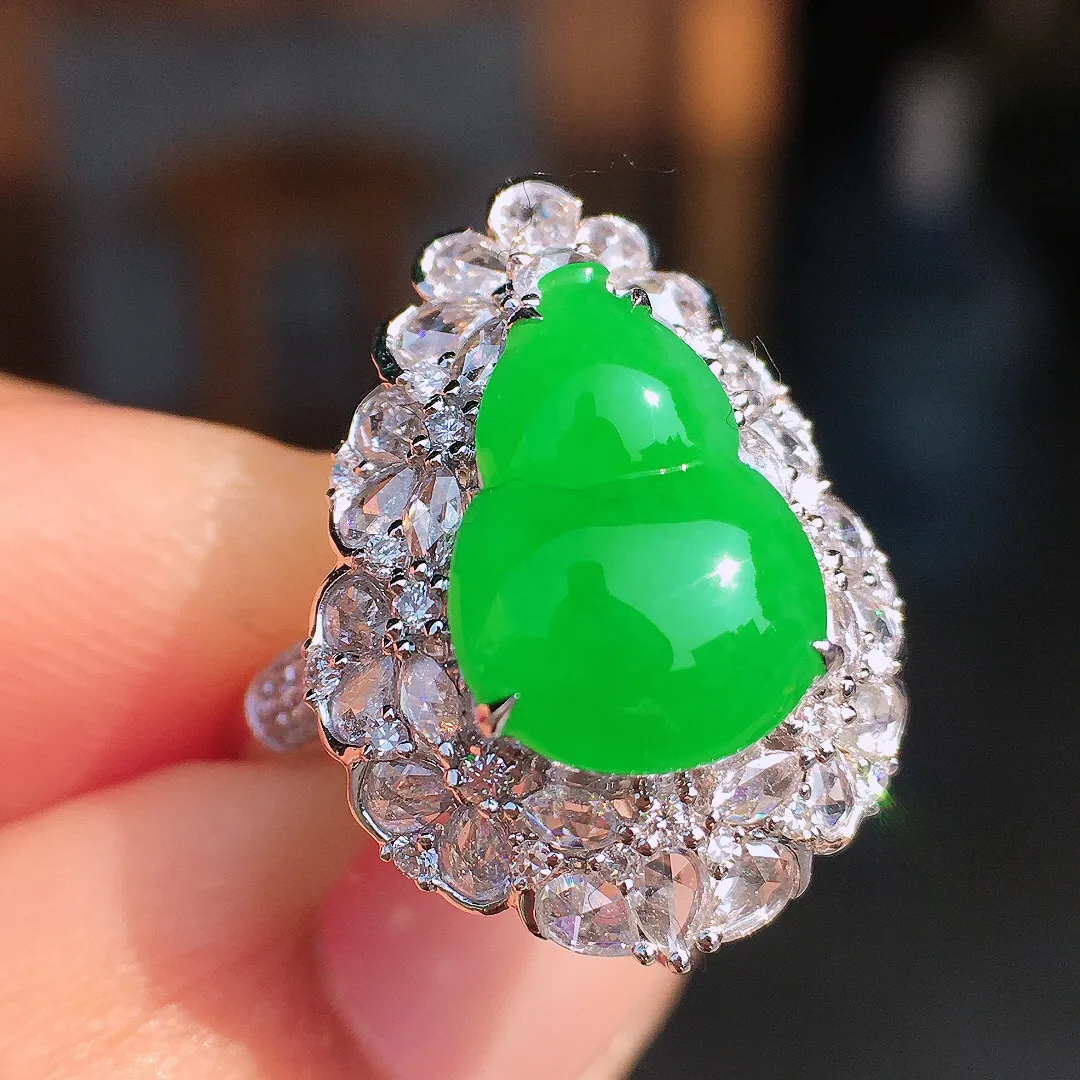 阳绿葫芦戒指，色泽均匀艳丽，玉质细腻，荧光感超
强，饱满圆润，尽显优雅气质，18k
金豪华镶嵌